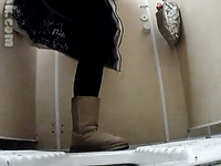 White chick in uggs and coat pisses in the public toilet