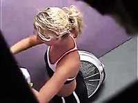 Sport blonde is changing her clothes in the dressing room