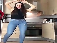 Hot brunette dancing in the kitchen for you