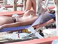 Natural sexy brunette amateur hottie was sunbathing topless on beach