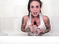 Tattooed milf Joanna Angel is playing with anal plug and vibrator in the bathroom